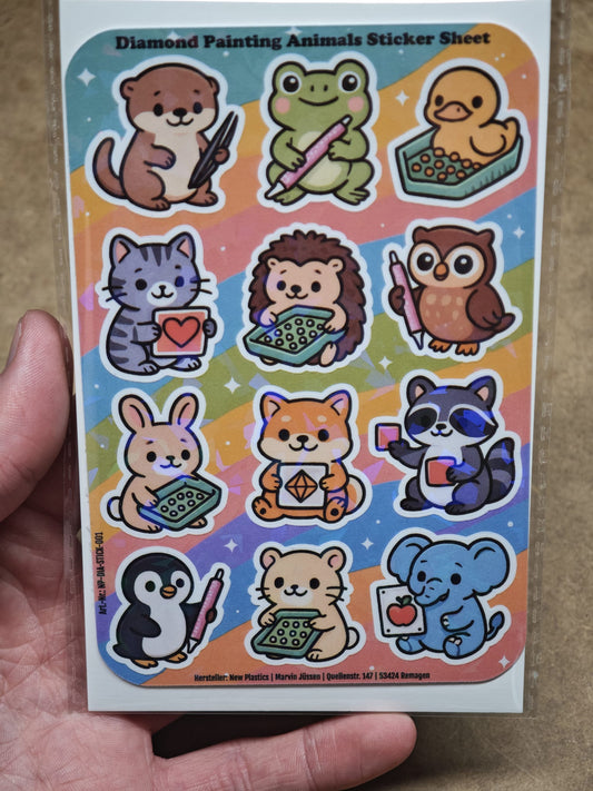 Eine Hand hält den New Plastics Diamond Painting Animals Sticker Sheet mit 12 Stickern (ca. DIN A6) mit niedlichen Vinyl-Aufklebern von Tieren wie einem Bären, einem Igel und einem Pinguin auf einem leuchtenden Regenbogenhintergrund – ideal für DIY-Projekte.