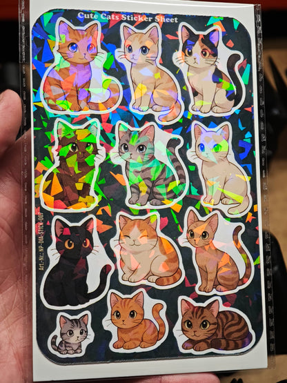 Eine Hand hält das „Cute Cats Sticker Sheet mit 12 Stickern ca. DIN A6“ von New Plastics – holografische Vinyl-Aufkleber mit bunten Cartoon-Katzen, die Regenbogenlicht reflektieren, ideal für DIY-Projekte.